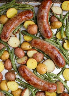 potatoes, green beans and sausage on a baking sheet