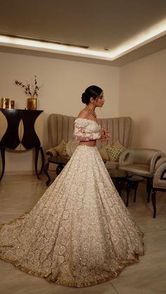 a woman in a wedding dress standing in a room