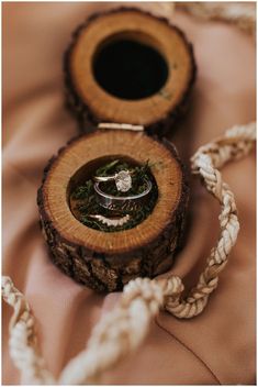 two wedding rings sitting in a wooden box