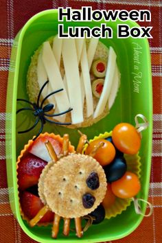 halloween lunch box with fruit, crackers and cheeses in the shape of a spider