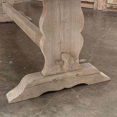 a wooden table sitting on top of a cement floor