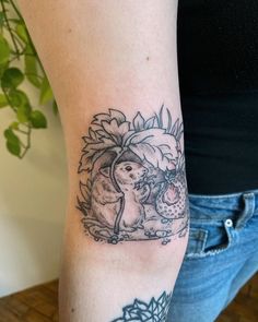 a woman with a tattoo on her arm holding an umbrella and two rabbits in the sunflowers