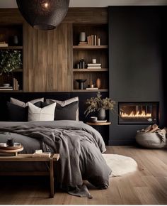 a bed room with a neatly made bed next to a fire place