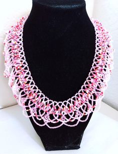 A handmade glass beaded necklace that is perfect for any occasion: parties, holidays, birthdays, anniversaries. All products are hand-crafted by my mother. Dimensions: - Actual Length: 24.1 cm - Collar Length: 20.5 cm - Width: 18.2 cm - Height: 2.0 mm Lightweight, high quality with a beaded hook as a clasp.  Acrylic Pearls: 8 mm. Will respond to concerns and suggestions promptly. Shipping costs: Free Domestic Shipping. All orders are sent by air-mail with tracking number. Time of delivery: Estimated 1-3 days for domestic shipping; international make take 7-14 days. Feel free to check out our other similar products! Link: https://noorsjewelers.etsy.com Handmade Beaded Bracelets With Round Beads For Celebration, Unique Beaded Necklaces With Round Beads For Celebration, Unique Handmade Pink Beads, Pink Handmade Custom Beads, Handmade Beaded Necklaces With Round Beads For Celebration, Handmade Pink Crystal Necklaces With Round Beads, Handmade Pink Crystal Bead Necklace, Adjustable Colorful Beads Necklace For Celebration, White Czech Glass Necklaces With Colorful Beads