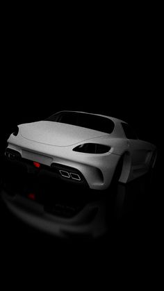 a white sports car is shown in the dark