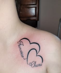 a woman's chest with two hearts and the word love written in cursive writing