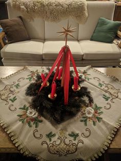 a living room with a couch and christmas decorations on the coffee table in front of it