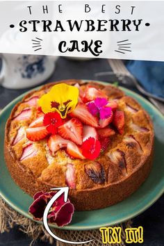 a cake with strawberries and flowers is on a plate next to a teapot