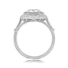 This ring features a 2.04-carat old European cut diamond, I color, and SI2 clarity. The center stone is surrounded by a halo of old mine and baguette-cut diamonds, and additional diamonds are set along the shoulders. The total weight of the additional diamonds is approximately 0.87 carats. This ring is handcrafted in platinum, with an openwork under-gallery and triple-wire shank.
The measurements of this ring are approximately 12.71mm x 12.55mm, including the halo.
This ring is currently sized a Classic Asscher Cut Halo Diamond Ring, Platinum Baguette Cut Halo Ring For Anniversary, Classic Diamond Ring With Halo Setting And Baguette Cut, Art Deco Platinum Cluster Ring With Halo Setting, Classic Diamond Ring With Baguette Cut And Halo Setting, Heirloom Platinum Diamond Ring With Halo Design, Classic Baguette Cut Diamond Ring With Halo Setting, Heirloom Halo Marquise Cut Diamond Ring, Classic Platinum Diamond Ring With Halo