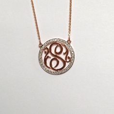 "The outer circle measures 0.75\" in diameter and is covered with beautiful F-G color, VS2-SI1 clarity diamonds. The outline is covered with approximately 40 brilliant, full-cut, round diamonds with a weight of 0.50 ct. In this absolutely stunning necklace, a diamond covered outline frames a gorgeous script single initial. Also, the 14k gold plate is significantly thicker and heavier than the plate used for our traditional monograms. This is necessary to accommodate the diamonds. This necklace c Circular Diamond Necklace With Accents As Gift, Circular Diamond Necklace With Accents For Gift, Elegant Monogram Jewelry With Cubic Zirconia, Elegant Monogram Cubic Zirconia Jewelry, Elegant Monogrammed Cubic Zirconia Jewelry, Fine Jewelry Diamond Necklace With Initials, Fine Jewelry Round Diamond Necklace With Initials, Round Diamond Necklace With Initials In Fine Jewelry Style, Elegant Personalized Diamond Necklace