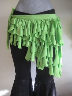 there is a mannequin with green ruffles on it's skirt