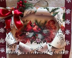 a christmas card with a cardinal and pine cones