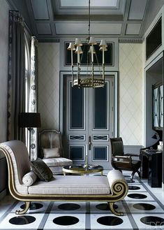 a living room filled with furniture and a chandelier