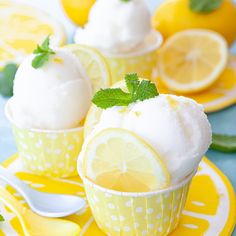 two lemon cupcakes with ice cream and mint on top