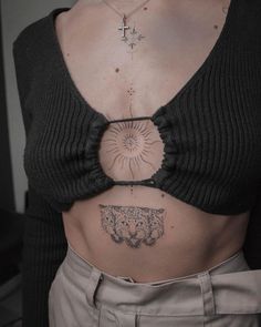 a woman with tattoos on her stomach