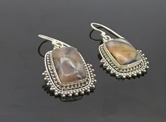 "925 Sterling Silver - Vintage Agate Shiny Twist Border Dangle Earrings - EG3782  925 Sterling Silver - Vintage Agate Shiny Twist Border Dangle Earrings - EG3782  Jewelry Type:         Earrings   Metal Type:            925 Silver   Metal Size:             1.5\"  Stone Type:            Agate   Condition:              N/A  Jewelry Weight:     7.3 Grams  PLEASE NOTE: THIS ITEM IS PRE-OWNED. ALTHOUGH MOST ITEMS ARE IN VERY GOOD CONDITION, SOME MAY NEED CLEANING AND/OR MINOR REPAIRS. WE MAKE A VERY STRONG EFFORT TO UPLOAD CLEAR PICTURES. PLEASE INSPECT ALL PICTURES AND ASK ALL QUESTIONS YOU MAY HAVE PRIOR TO MAKING A PURCHASE. NOT ALL STONES ARE GENUINE, SOME ARE ENHANCED OR CREATED." Elegant Silver Agate Earrings, Silver Agate Gemstone Earrings, Pierced Silver Agate Jewelry, Silver Agate Jewelry, Earrings Metal, Types Of Metal, Metallic Silver, 925 Silver, Agate