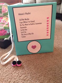 an electronic device sitting on the floor next to a pair of shoes and a string