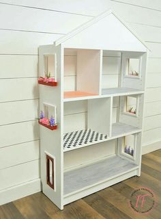 a doll house made out of wood and painted white