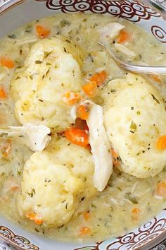 a bowl filled with chicken and dumplings next to a spoon