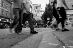 black and white photograph of people walking down the street