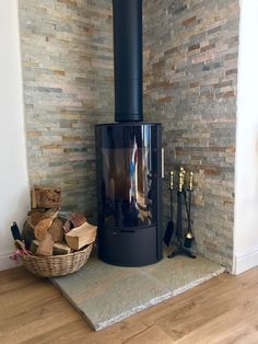 a wood burning stove sitting next to a pile of firewood