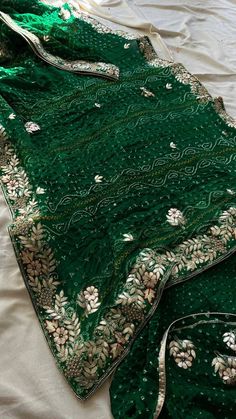 Welcome to our exquisite collection of Green Bhandej Saree, perfect for those special occasions like weddings, parties, and festive gatherings. This Bollywood-style saree is crafted with utmost care and attention to detail, ensuring a premium quality product that you will adore. The saree comes with a matching unstitched blouse piece, adding to its versatility and charm. The beautiful fall and edging are already done, giving the saree an elegant drape. You have the option to choose tassels for an extra touch of grace and style. Saree Details: Saree Color: Green Bhandej Saree Length: 5.5 meters Blouse Piece Length: 0.8 meters Wash Instruction: Dry Clean Only *Please note that the petticoat and ready to wear saree options are available upon request with additional charges. Whether you want t Bandhani Print Dupatta For Diwali, Wedding Anarkali Set With Bandhani Print In Georgette, Green Kundan Bollywood Saree, Traditional Green Choli With Gota Work, Navratri Kundan Pre-draped Saree With Dupatta, Wedding Banarasi Silk Choli With Dabka Work, Semi-stitched Bandhani Anarkali Set For Wedding, Chanderi Bandhani Print Anarkali Set For Wedding, Wedding Semi-stitched Anarkali Set With Bandhani Print