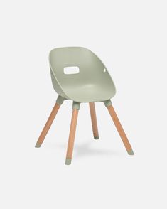 a light green chair with wooden legs and a hole in the backrest, on a white background