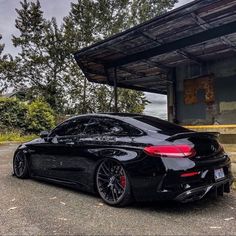 a black car parked in front of a building