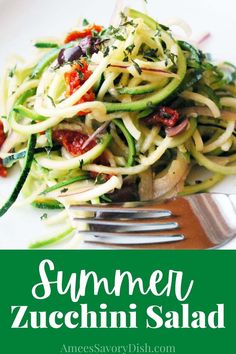 a white plate topped with zucchini salad next to a fork