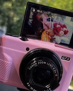 a pink camera sitting on top of a table