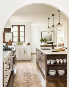 an archway in the middle of a kitchen