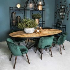 a dining room table with green chairs around it