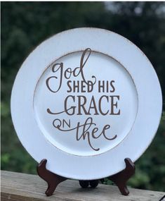 a white plate with the words god shed his grace on thee written in black ink