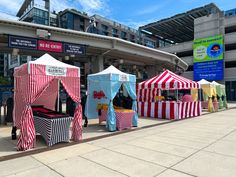 several tents are set up in front of a building