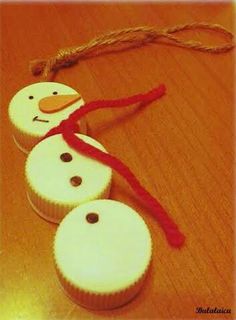 three frosted cupcakes are sitting on a wooden table with a red ribbon