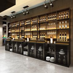 an empty bar with many bottles on the shelves