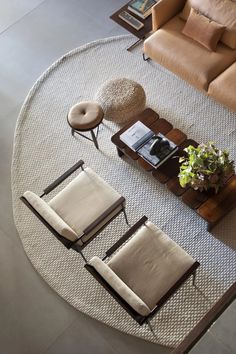 an overhead view of a living room with two chairs and a coffee table in the middle