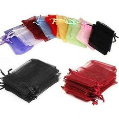 various colors of organe bags with ties and draws on the bottom, all lined up in