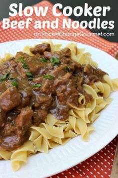 slow cooker beef and noodles on a white plate with red checkered table cloth