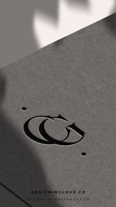 the logo for designing love co is shown on top of a gray book with black lettering