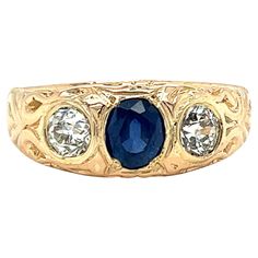 One 14 karat yellow gold Edwardian three stone ring, set with one (1) 6x5mm natural oval sapphire, flanked by two (2) 5.1mm old mine cut diamonds, approximately 1.00 carat total weight with matching IJK color and VVS2-SI1 clarity. The ring is a finger size 11.25 and is resizable. Sizing is not included. The ring weighs 7.3 grams in total weight. Exquisite Gold Multi-stone Sapphire Ring, 14k Gold Multi-stone Oval Cabochon Ring, Luxury Multi-stone Vintage Sapphire Ring, Vintage Yellow Gold Sapphire Jewelry, Oval Cabochon, Yellow Gold Multi-stone Oval Cabochon Gemstones, Domed Ring, Three Stone Rings, Three Stone, Stone Rings