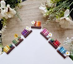 a close up of a cake decorated with legos and flowers on a wooden table