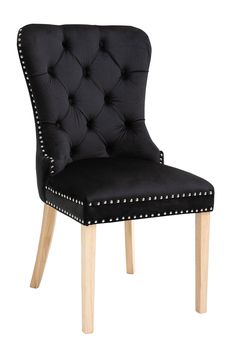 a black chair with wooden legs and studded upholstered back