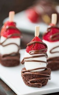 chocolate desserts with strawberries are on a white plate