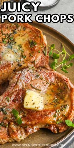 juicy pork chops on a plate with herbs