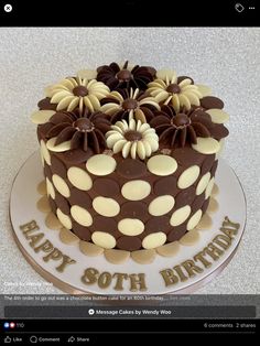 a birthday cake decorated with chocolate and white flowers