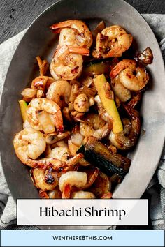 a bowl filled with shrimp and vegetables on top of a table