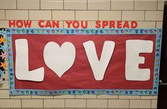 a bulletin board that says how can you spread love on the wall in front of it