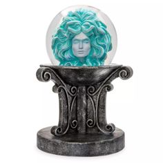 a snow globe with a woman's head inside it on a pedestal, against a white background