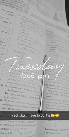 an open book sitting on top of a table next to a pen and paper with the words tuesday